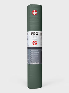 Manduka PROlite green yoga mat rolled up front view with logo and product information label