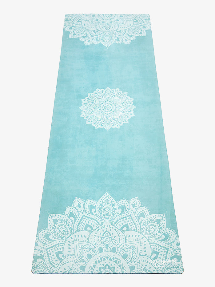 Teal yoga mat with white mandala design, non-slip texture, eco-friendly material, full-length front view